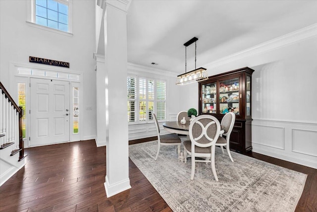 1003 Jervey Point Rd, Wando, SC 29492 - dining space with stairs, ornamental molding, dark wood-style flooring, ornate columns, and wainscoting
