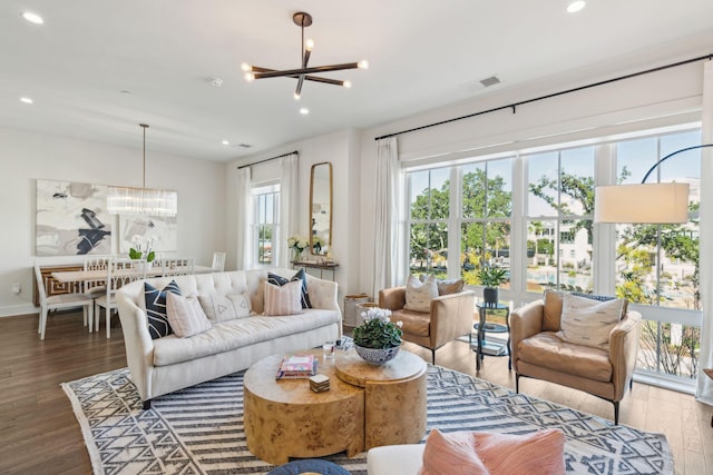 living room featuring hardwood / wood-style floors and an inviting chandelier