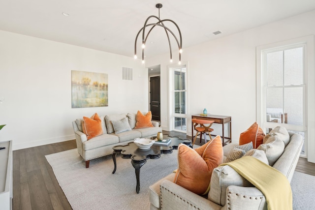 living room with dark hardwood / wood-style flooring and a chandelier