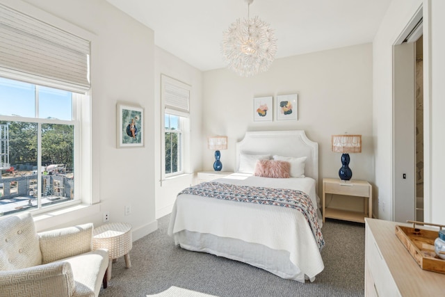 carpeted bedroom featuring an inviting chandelier and multiple windows