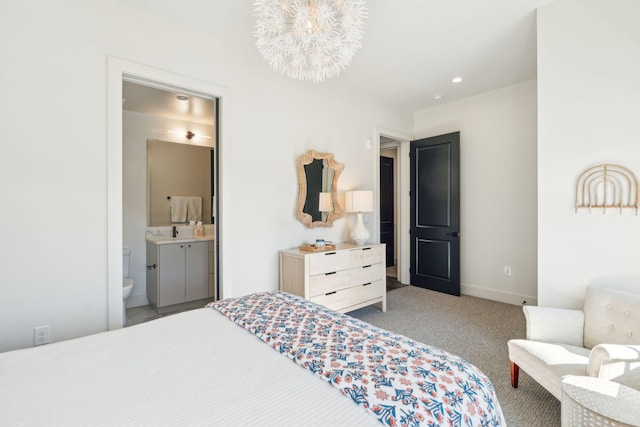 bedroom featuring connected bathroom, carpet floors, a notable chandelier, and sink