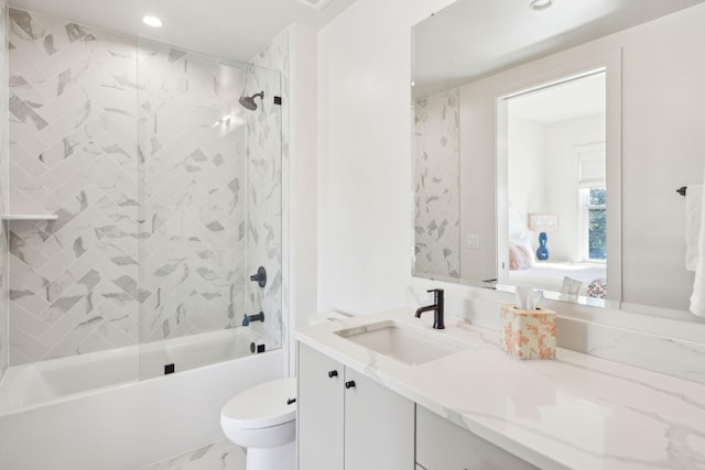 full bathroom with vanity, tiled shower / bath combo, and toilet