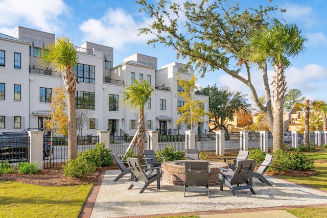 view of home's community featuring a fire pit and a patio area