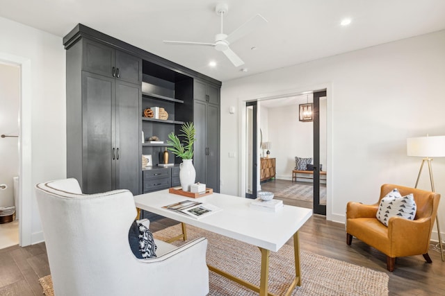 home office featuring ceiling fan and dark wood-type flooring