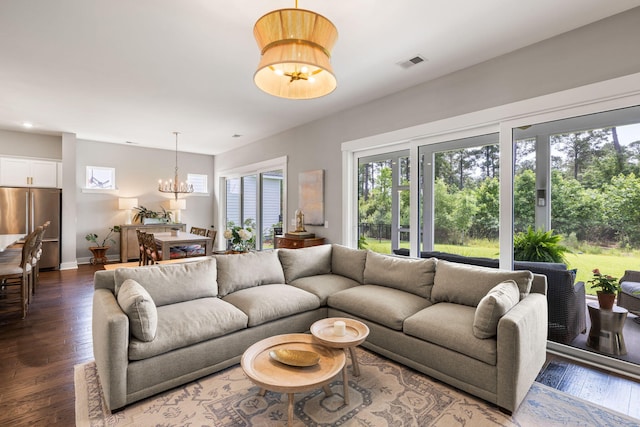 125 Integrity Ln, Charleston, SC 29492 - living area with a chandelier, healthy amount of natural light, dark wood-style floors, and baseboards