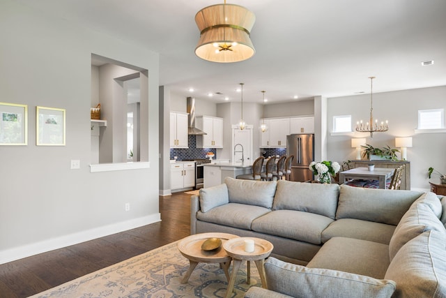 125 Integrity Ln, Charleston, SC 29492 - living room featuring a chandelier, dark wood-style flooring, and baseboards
