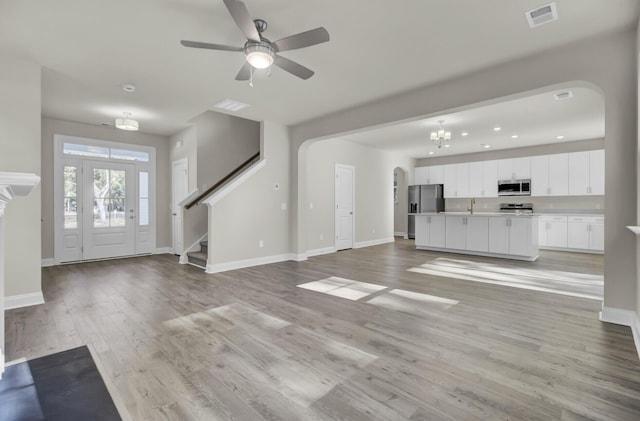 125 Integrity Ln, Charleston, SC 29492 - unfurnished living room with arched walkways, baseboards, and recessed lighting
