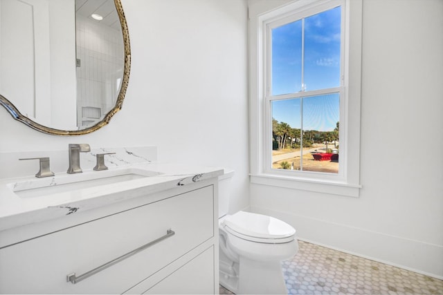 bathroom with vanity, a shower, and toilet