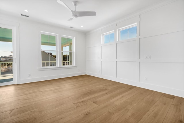 unfurnished room featuring a wealth of natural light, light hardwood / wood-style floors, and ceiling fan