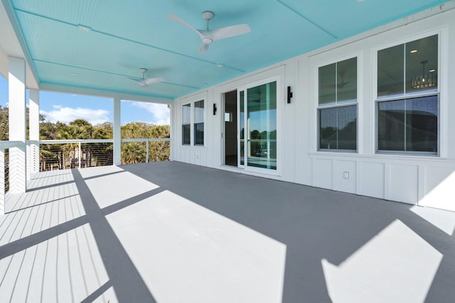 unfurnished sunroom with ceiling fan