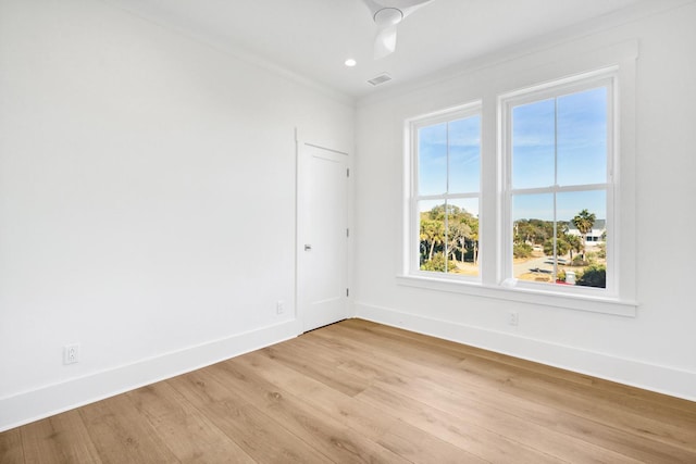 empty room with light hardwood / wood-style flooring and ornamental molding