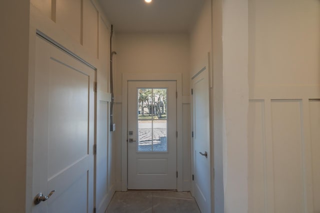 doorway with light tile patterned floors