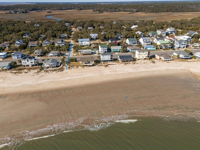 bird's eye view with a water view and a beach view