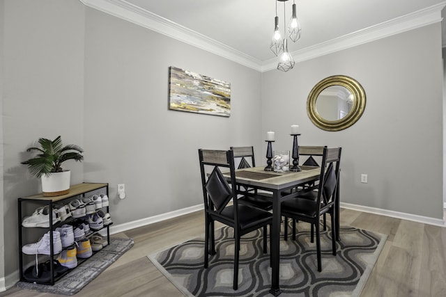 dining room featuring wood-type flooring and ornamental molding