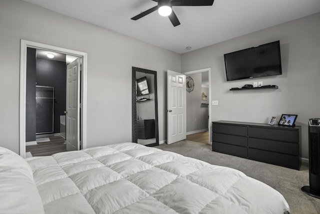 carpeted bedroom featuring ceiling fan and ensuite bath