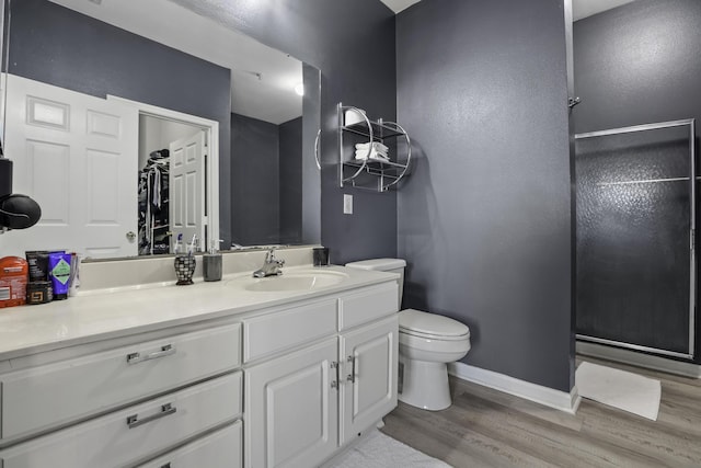 bathroom featuring hardwood / wood-style floors, vanity, and toilet