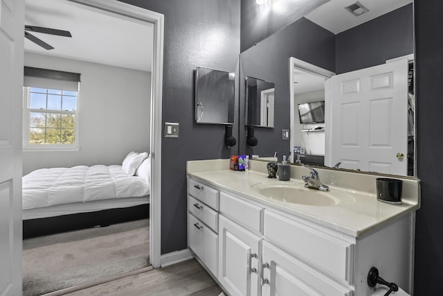 bathroom with ceiling fan, vanity, and hardwood / wood-style flooring