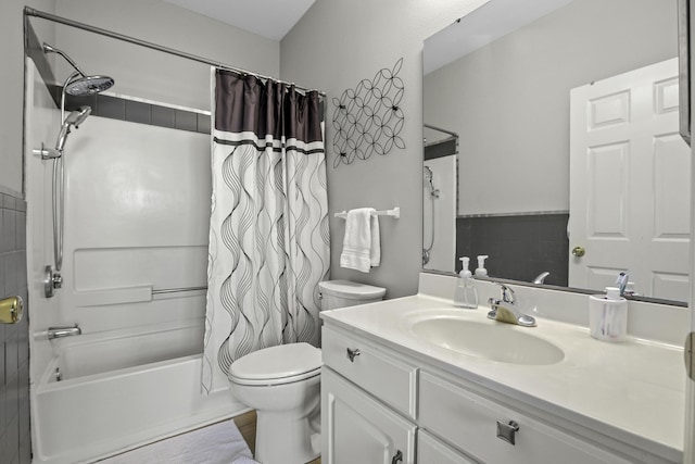 full bathroom with vanity, shower / bath combination with curtain, and toilet