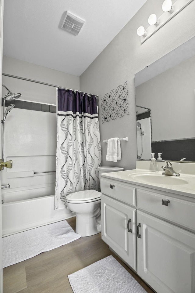 full bathroom featuring hardwood / wood-style floors, vanity, toilet, and shower / bath combo with shower curtain