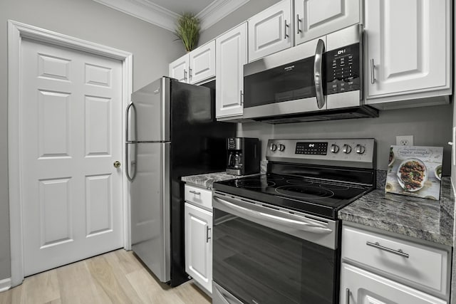 kitchen with appliances with stainless steel finishes, ornamental molding, stone countertops, light hardwood / wood-style floors, and white cabinetry