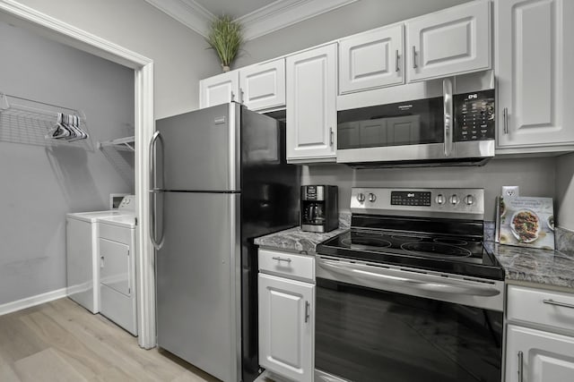 kitchen with appliances with stainless steel finishes, crown molding, stone countertops, washing machine and clothes dryer, and white cabinets