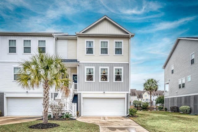 coastal inspired home featuring a front lawn, an attached garage, stairway, and concrete driveway
