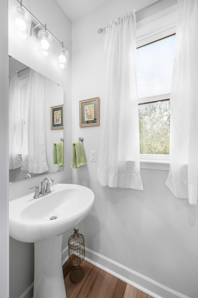 bathroom with baseboards and wood finished floors