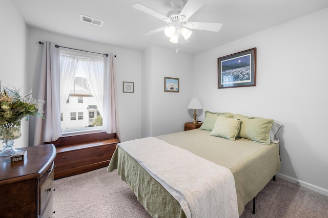 bedroom with ceiling fan, baseboards, light colored carpet, and visible vents