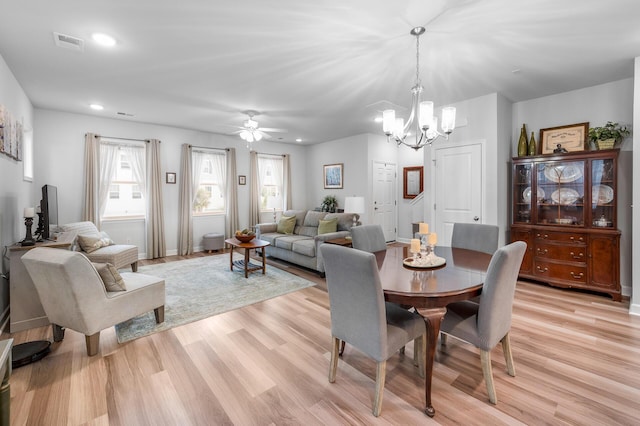 dining room featuring visible vents, recessed lighting, ceiling fan with notable chandelier, and light wood finished floors
