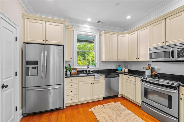 656 Coleman Blvd Unit 405, Mount Pleasant, SC 29464 - kitchen featuring a sink, crown molding, stainless steel appliances, and cream cabinetry