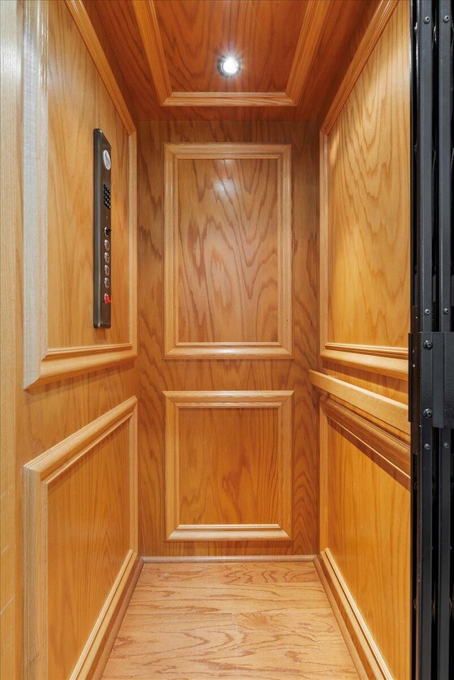 656 Coleman Blvd Unit 405, Mount Pleasant, SC 29464 - interior details with elevator, wood walls, and ornamental molding