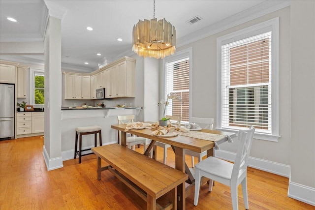 656 Coleman Blvd Unit 405, Mount Pleasant, SC 29464 - dining area featuring baseboards, visible vents, crown molding, a notable chandelier, and light wood-style floors
