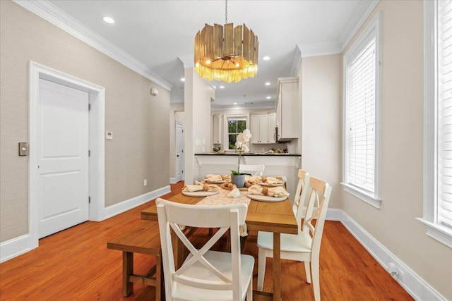 656 Coleman Blvd Unit 405, Mount Pleasant, SC 29464 - dining space featuring baseboards, ornamental molding, a chandelier, and light wood-type flooring