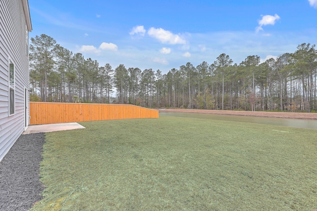 view of yard with a view of trees