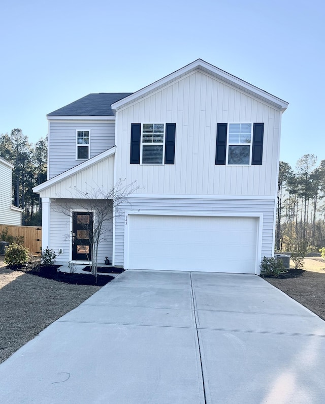 view of front facade with concrete driveway and an attached garage