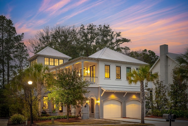 view of front of property with a balcony and a garage