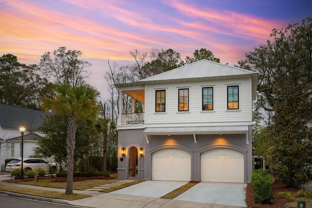 view of front facade featuring a balcony and a garage