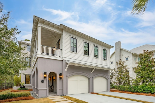 view of front of home with a balcony and a garage