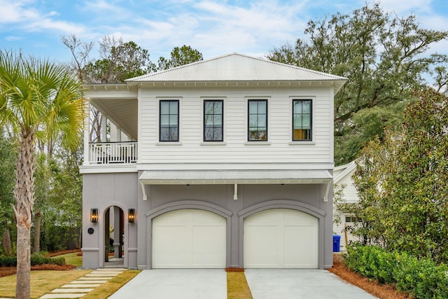 view of front of home with a balcony and a garage