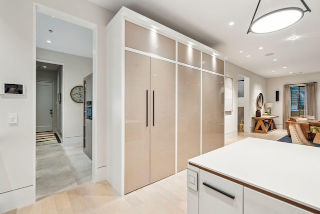 kitchen featuring light hardwood / wood-style flooring and white cabinetry