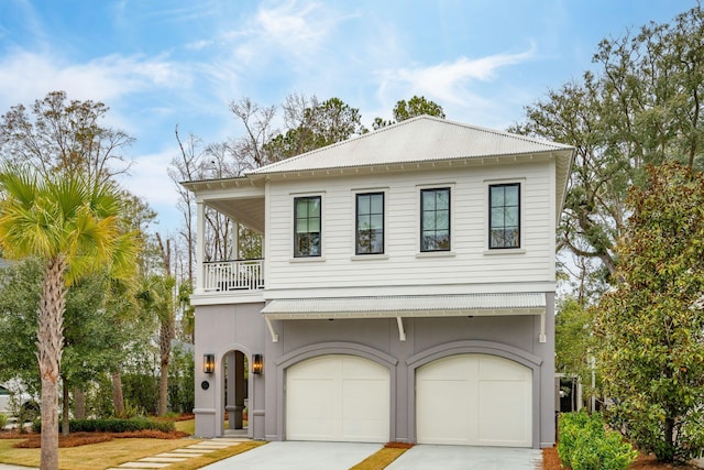 view of front of property featuring a balcony and a garage