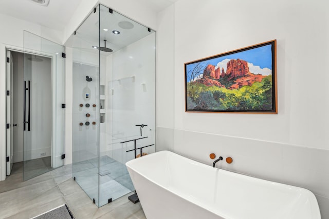 bathroom featuring shower with separate bathtub