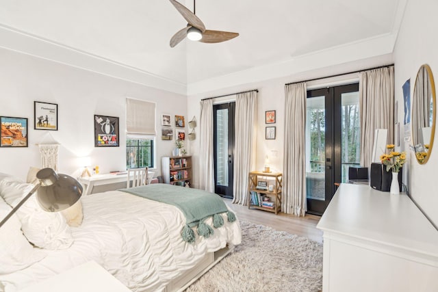 bedroom featuring french doors, lofted ceiling, light wood-type flooring, ceiling fan, and access to exterior