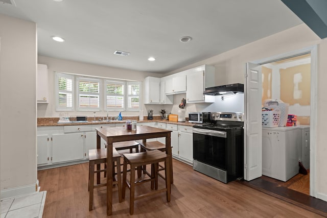 2170 Midland Park Rd, North Charleston, SC 29406 - kitchen with stainless steel appliances, under cabinet range hood, white cabinets, wood finished floors, and recessed lighting