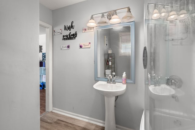 2170 Midland Park Rd, North Charleston, SC 29406 - bathroom with wood finished floors and washtub / shower combination
