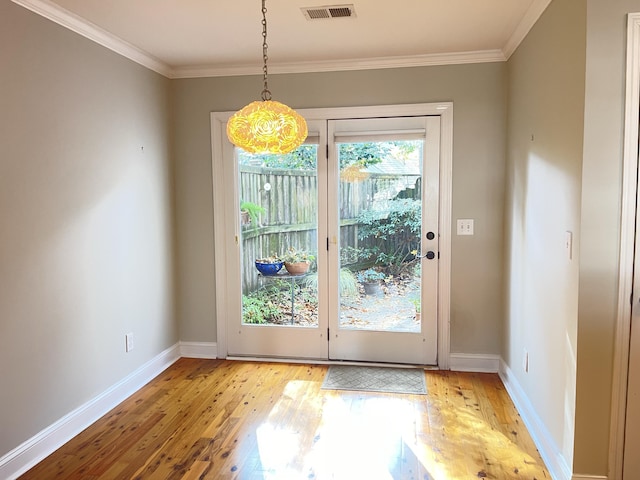 doorway to outside featuring crown molding and light wood-type flooring