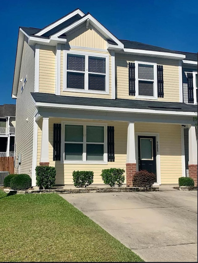 9088 Parlor Dr, Ladson, SC 29456 - craftsman-style house featuring a porch, a front yard, board and batten siding, and central AC