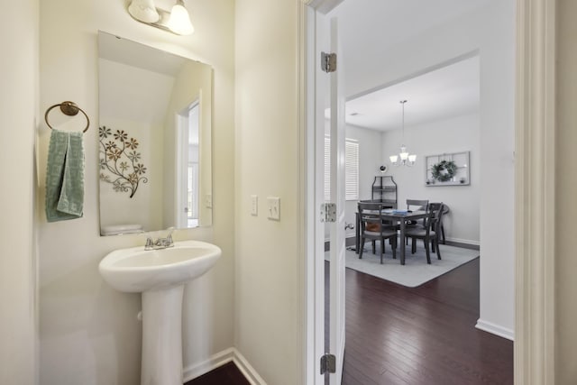 9088 Parlor Dr, Ladson, SC 29456 - bathroom featuring wood finished floors, baseboards, a sink, and a chandelier