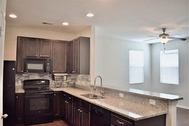 9088 Parlor Dr, Ladson, SC 29456 - kitchen with black appliances, a sink, a peninsula, backsplash, and recessed lighting