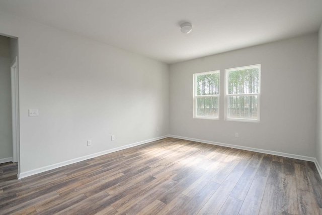 empty room featuring dark hardwood / wood-style flooring